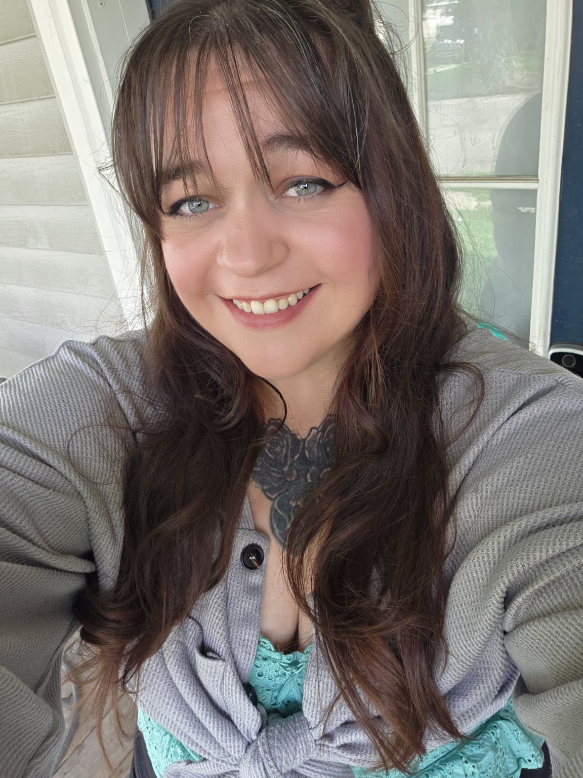 Angelia N. Bailey smiling, wearing a gray cardigan and teal top